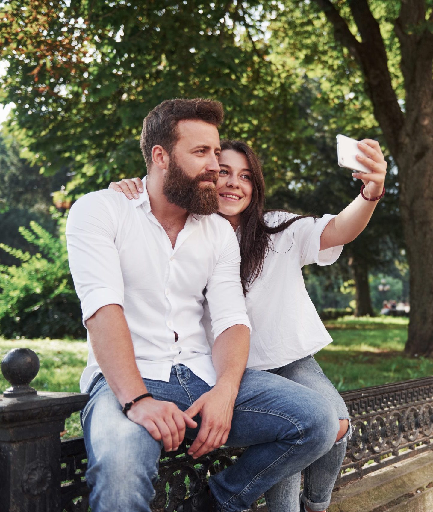 A beautiful couple makes a photo outdoors